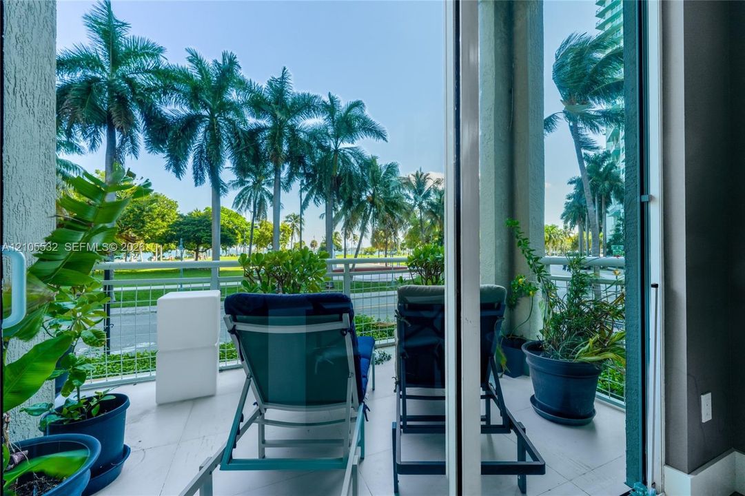 Private balcony featuring light-toned tile flooring and metal railing