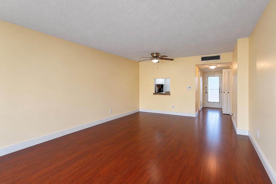 Bright Empty Living Room with Kitchen Pa