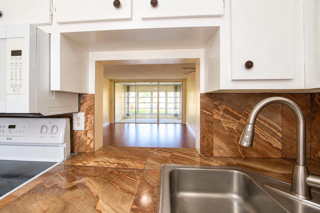 Kitchen Pass-Through to Sunlit Living Ro