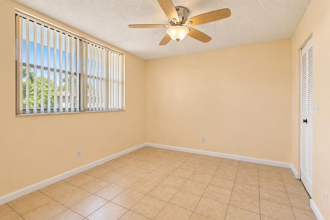 Bright Empty Beige-Tiled Bedroom