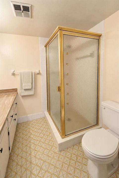 Retro Cream Bathroom with Gold-Framed Sh