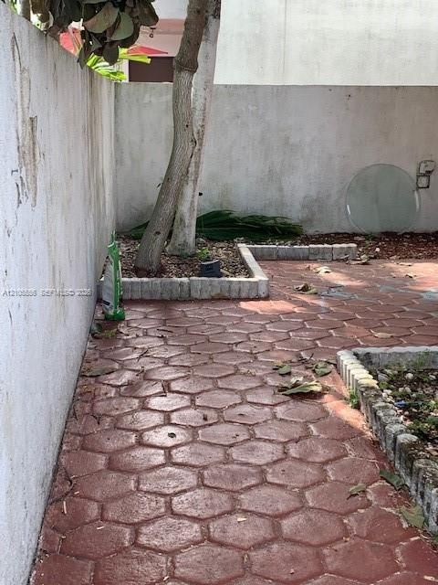 Red hexagonal patterned paving with stone border accents