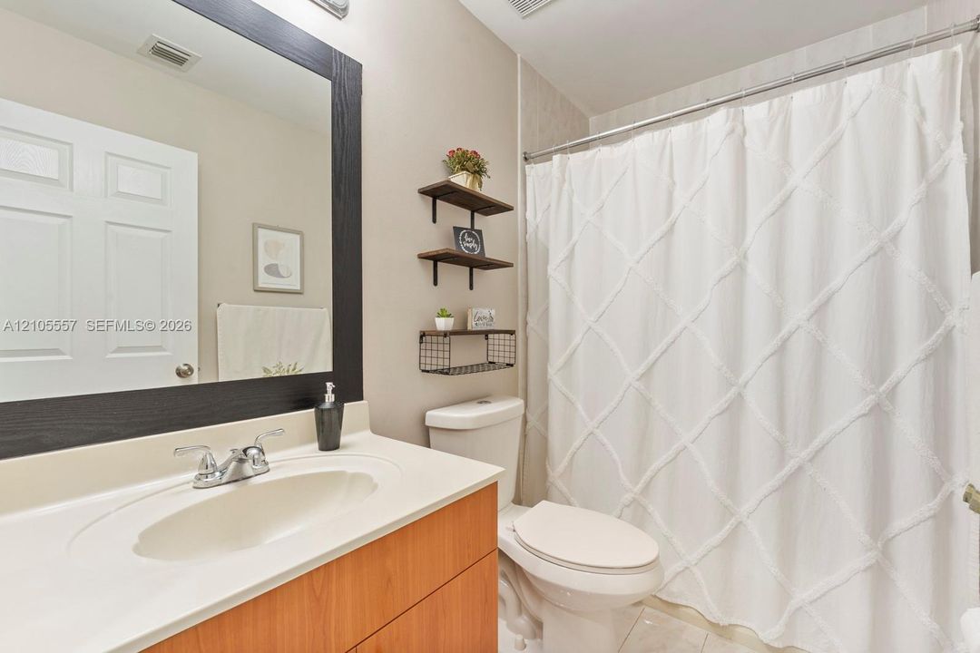 Integrated vanity with a single basin sink and a wood-finish cabinet