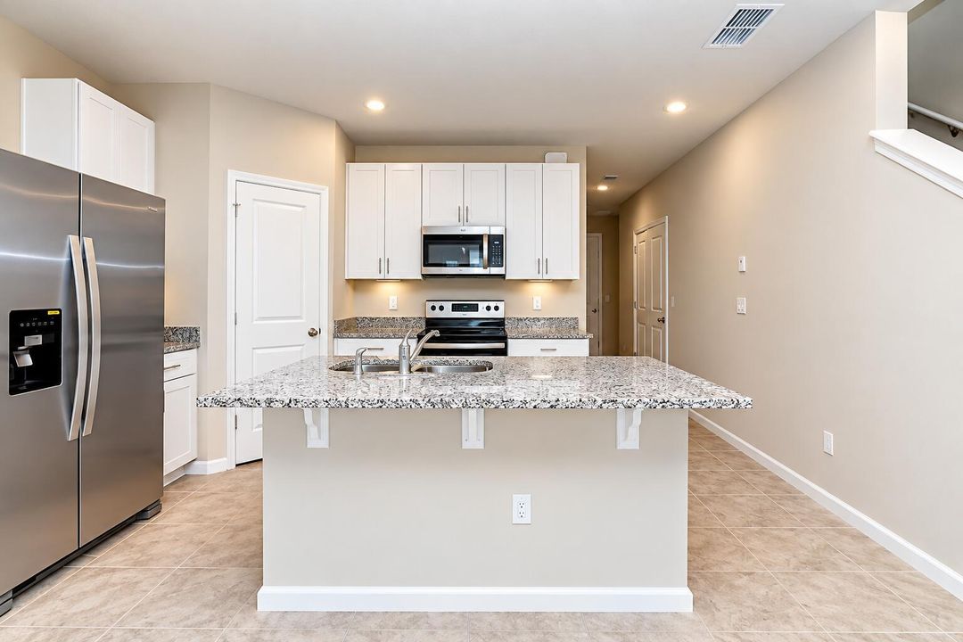 Modern Kitchen with Granite Island Sink
