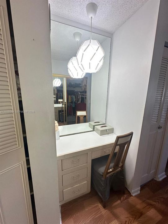 Built-in vanity with integrated storage drawers and a full-height mirror