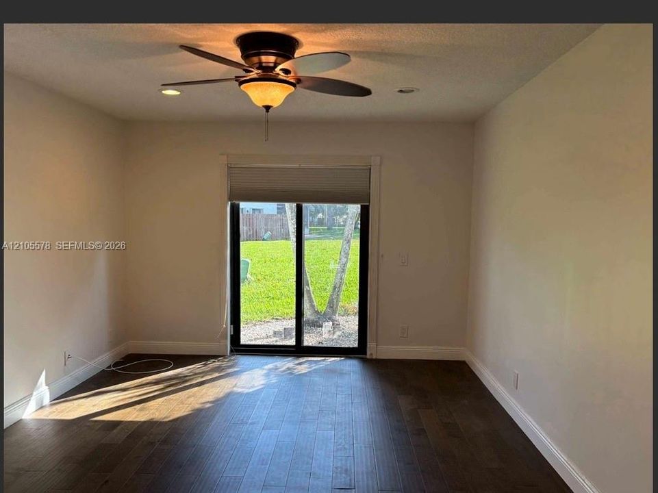 Interior space featuring wood-finish flooring, recessed lighting, and a multi-blade ceiling fan with an integrated light fixture