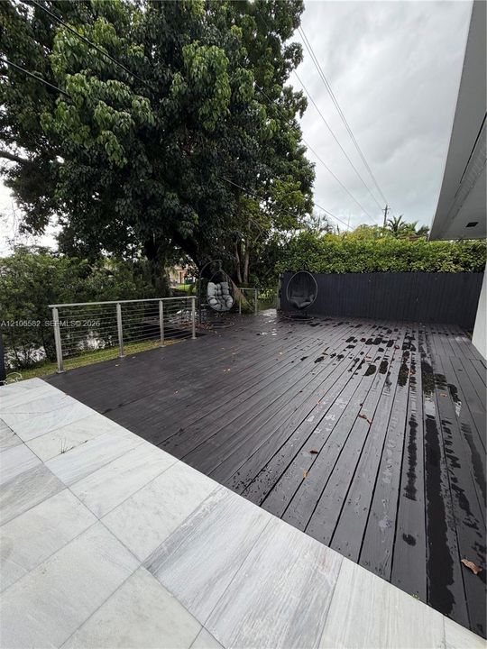 Expansive outdoor deck with dark wood-finish planking