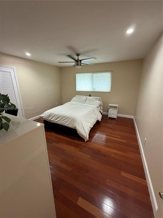 Hardwood flooring, recessed lighting, ceiling fan, louvered door, window with privacy blind