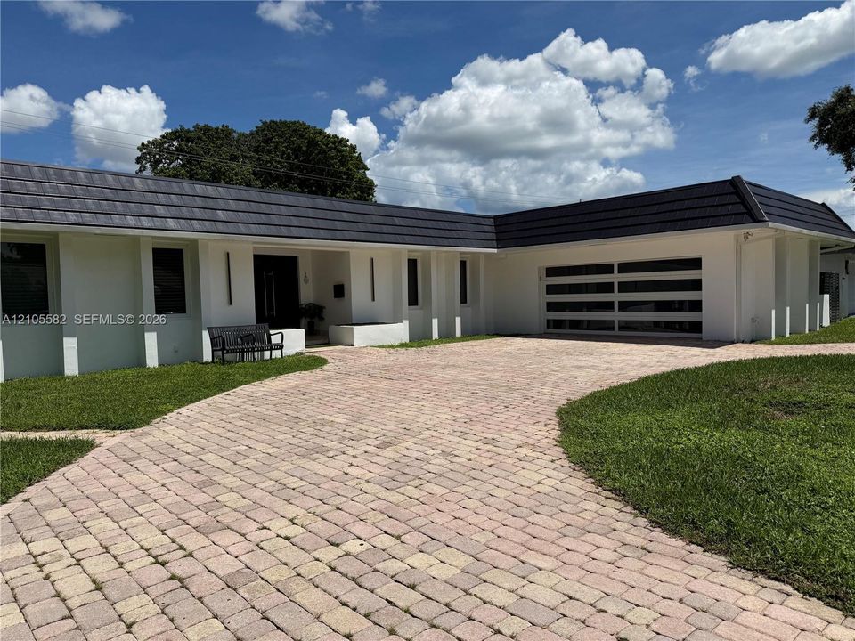 White stucco exterior with a dark tile roof