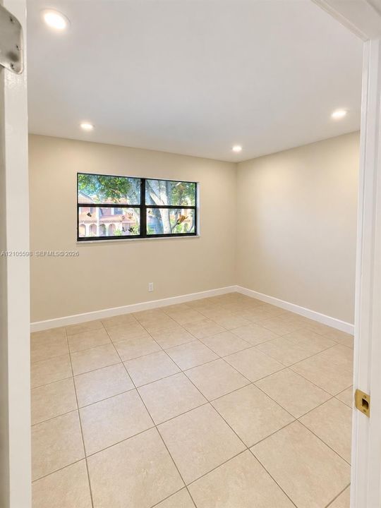 Recessed lighting, tile flooring, interior wall-mounted door, window with exterior scenery, neutral wall tones