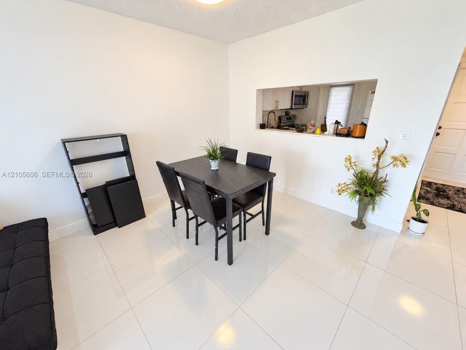 Glossy large-format tile flooring and a kitchen pass-through window