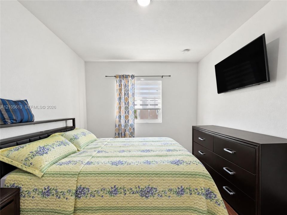 Neutral wall palette with single-pane window and overhead recessed lighting