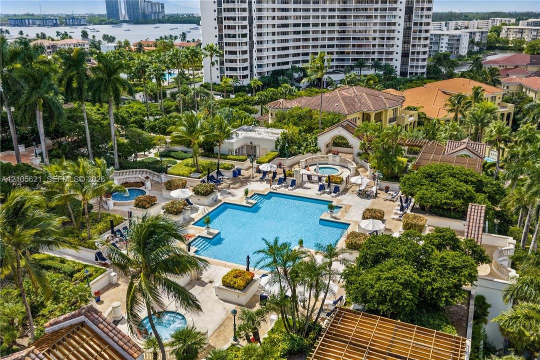 Common area amenities including a swimming pool, multiple spas, landscaped grounds, and wood-slat pergolas