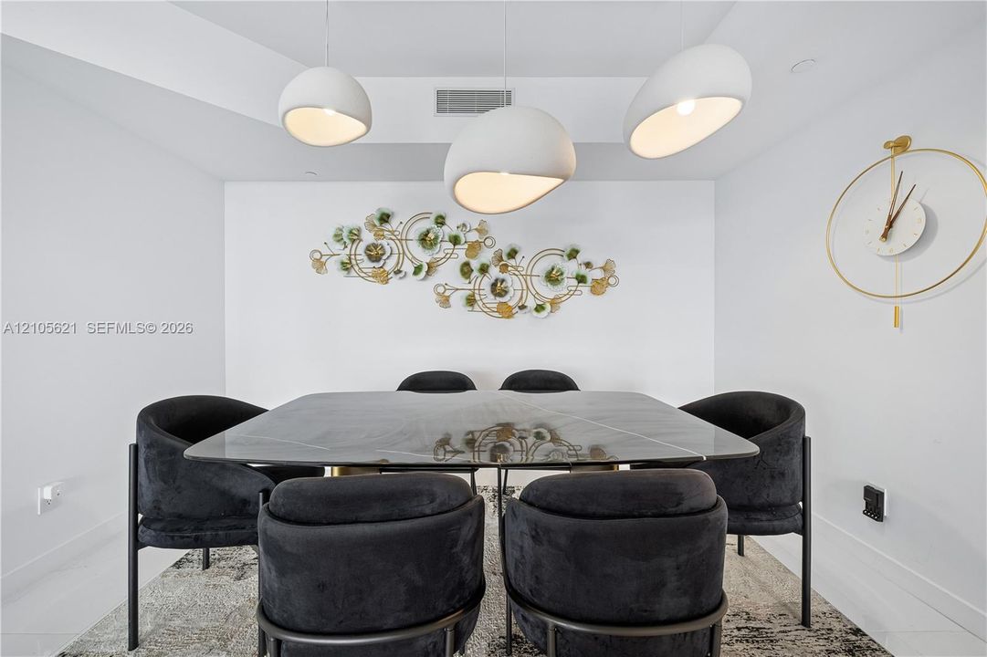 Modern interior featuring three sculptural, white pendant lights and a recessed ceiling tray