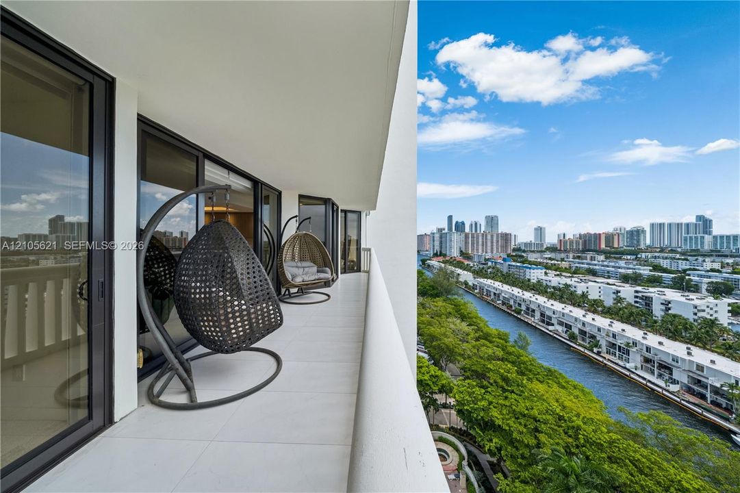 Covered balcony featuring tile flooring and floor-to-ceiling glass doors