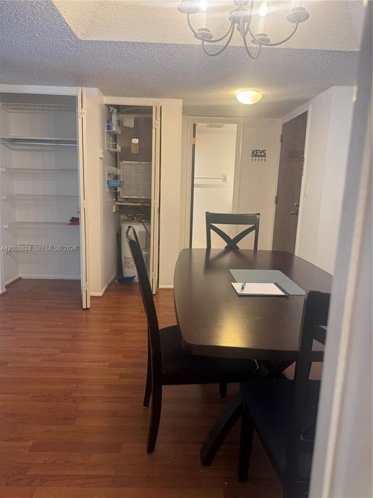 Wood-finish flooring, built-in wire shelving, and a dedicated laundry closet