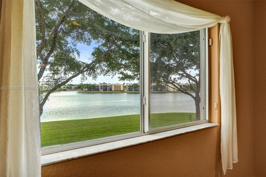 Large sliding glass window featuring a natural stone sill