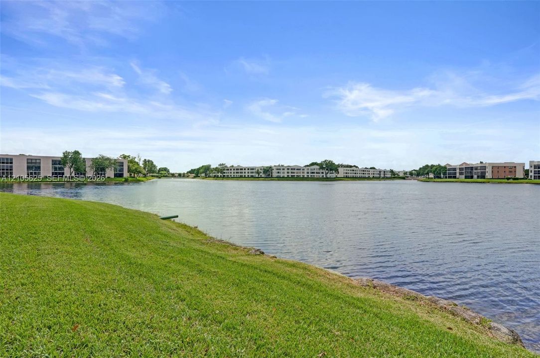 Waterfront property featuring an expansive grass lawn and lake frontage