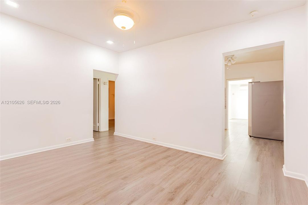 Interior space featuring wood-finish flooring, neutral wall tones, recessed lighting, and a central ceiling fan with an integrated light fixture