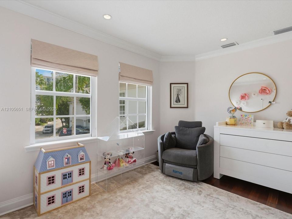 Neutral-toned room featuring crown molding, recessed lighting, grid-pattern windows, and dark-toned flooring