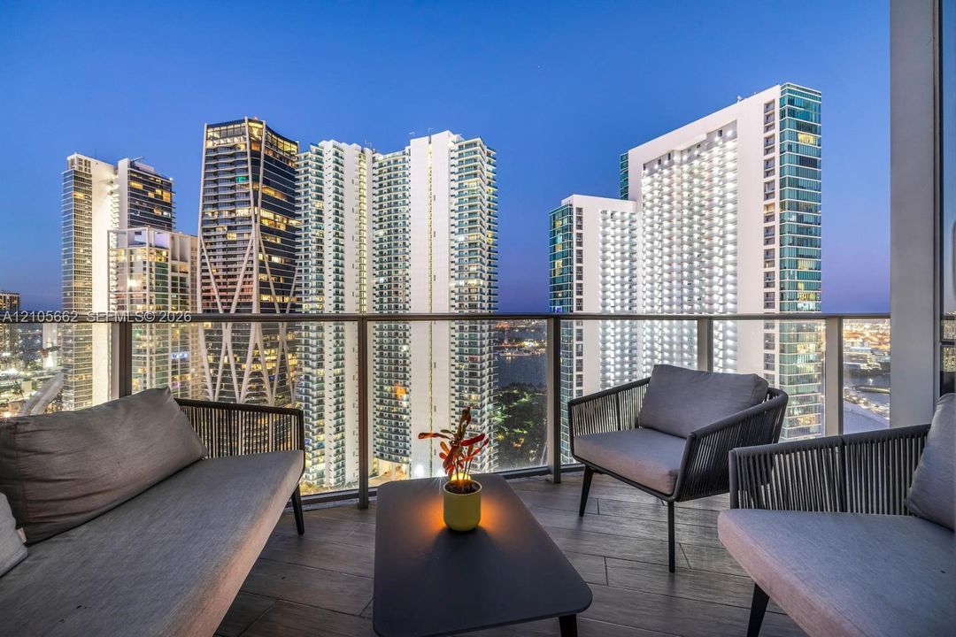 Private balcony featuring wood-finish flooring and glass panel railing