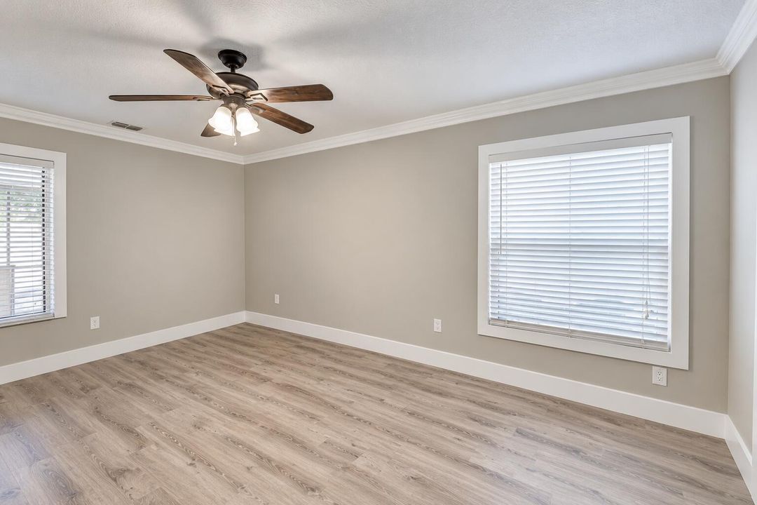 Empty Neutral-Toned Room with Ceiling Fa