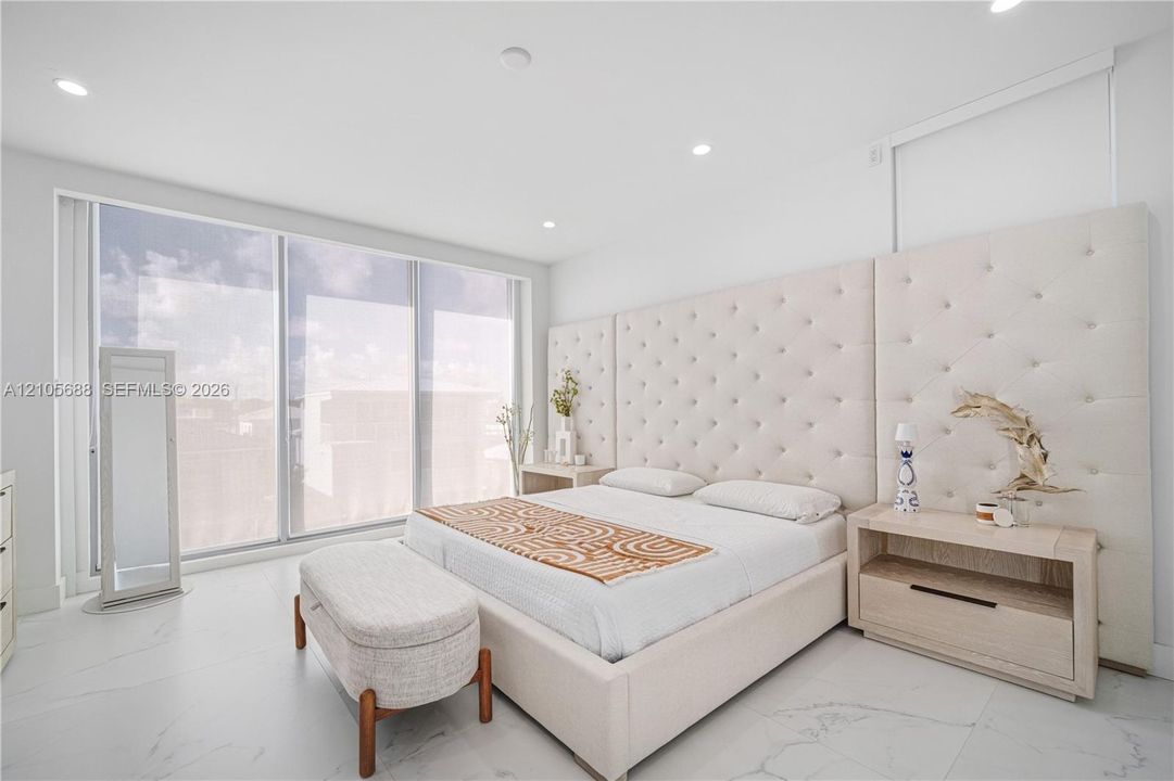 Master. Floor-to-ceiling windows, recessed lighting, and large-format tile flooring
