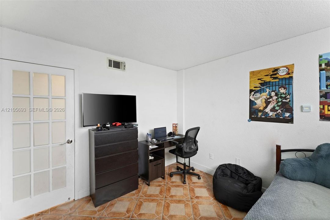 Room featuring tile flooring and a multi-pane glass door