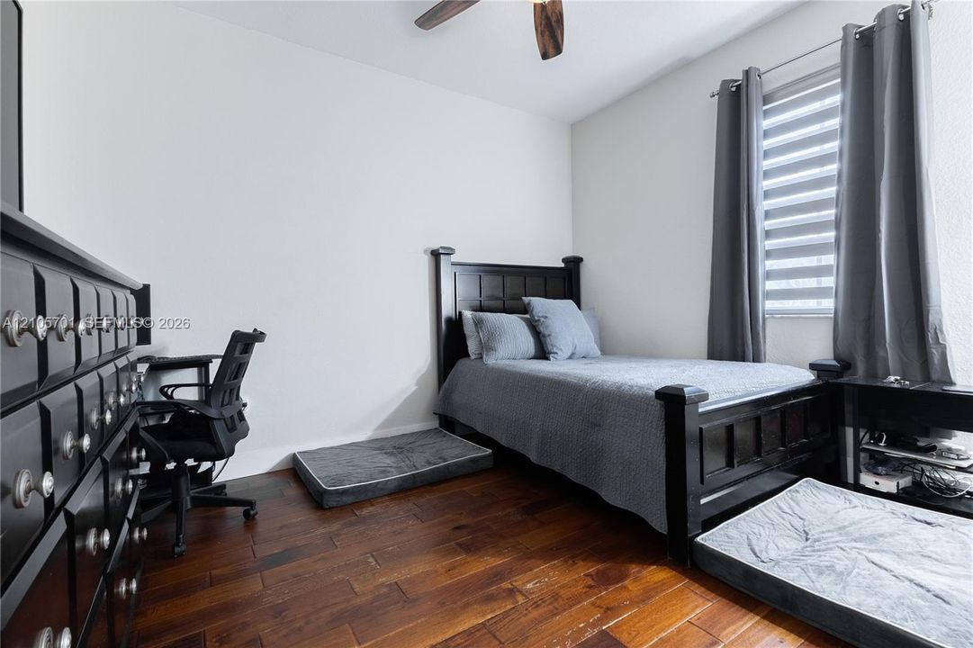 Wood-finish flooring, ceiling fan, and horizontal window blinds