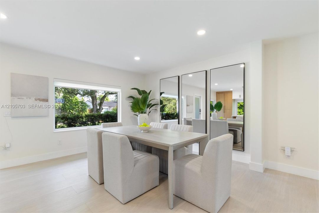 Neutral color palette featuring wood-finish flooring, recessed lighting, and large windows