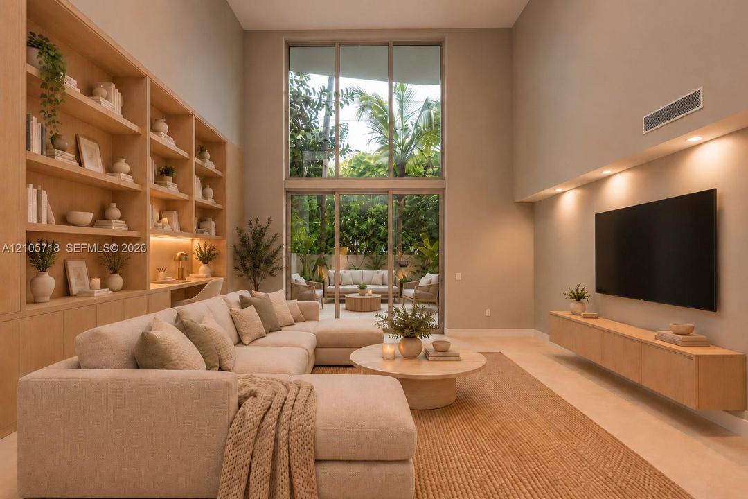 Double-height ceiling featuring expansive floor-to-ceiling windows, custom built-in light-tone wood shelving with integrated task lighting, and a wall-mounted floating media console