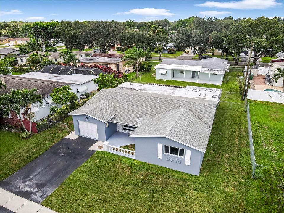 Single-story residence featuring a shingle roof, attached one-car garage, exterior shutters, and a concrete driveway on a landscaped lot