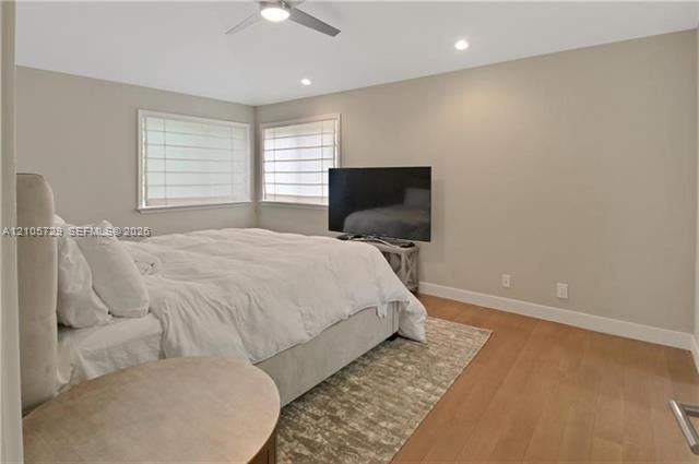 Room featuring wood-finish flooring, recessed lighting, and a ceiling fan