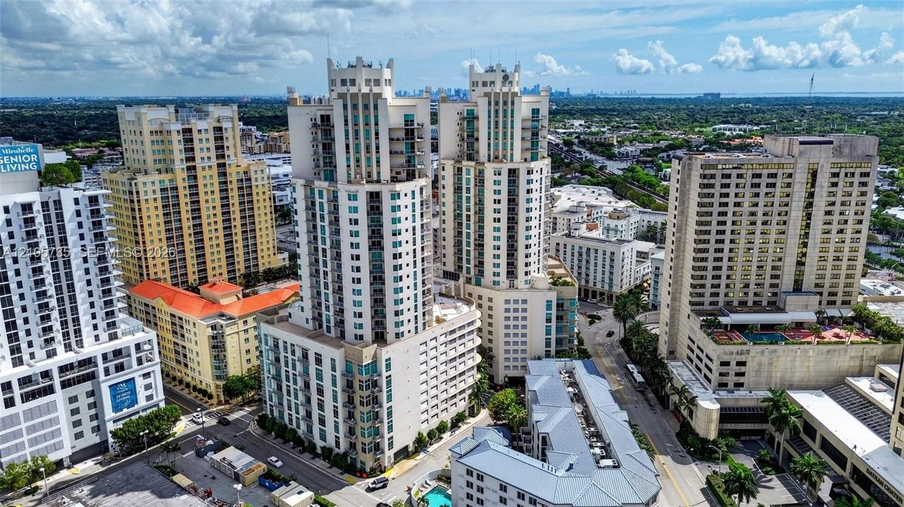 High-rise urban architecture featuring tiered facade detailing, expansive glass windows, and multiple balconies