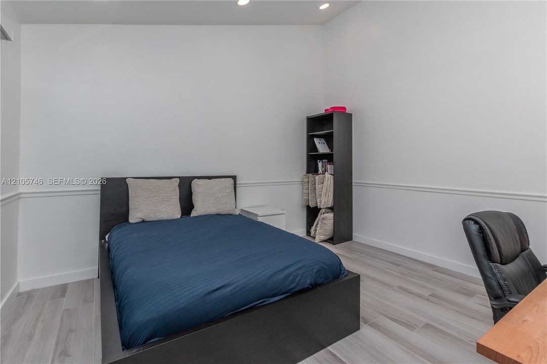 Wood-finish flooring, chair rail molding, and recessed ceiling lighting