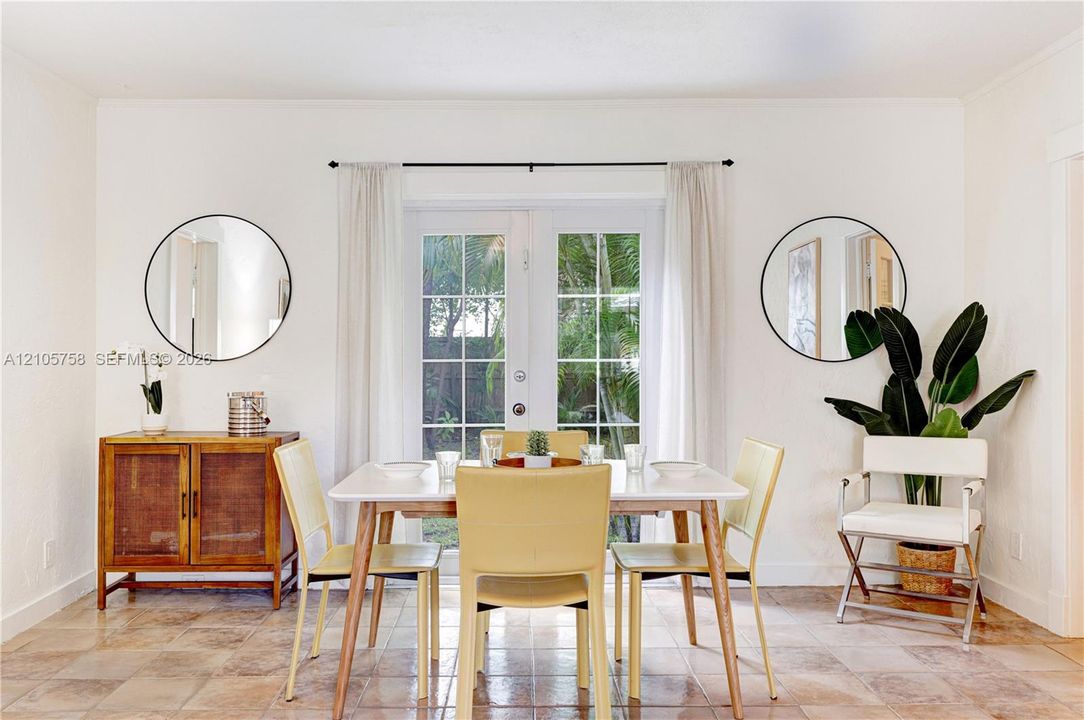 White-framed French doors with glass panes and tile flooring