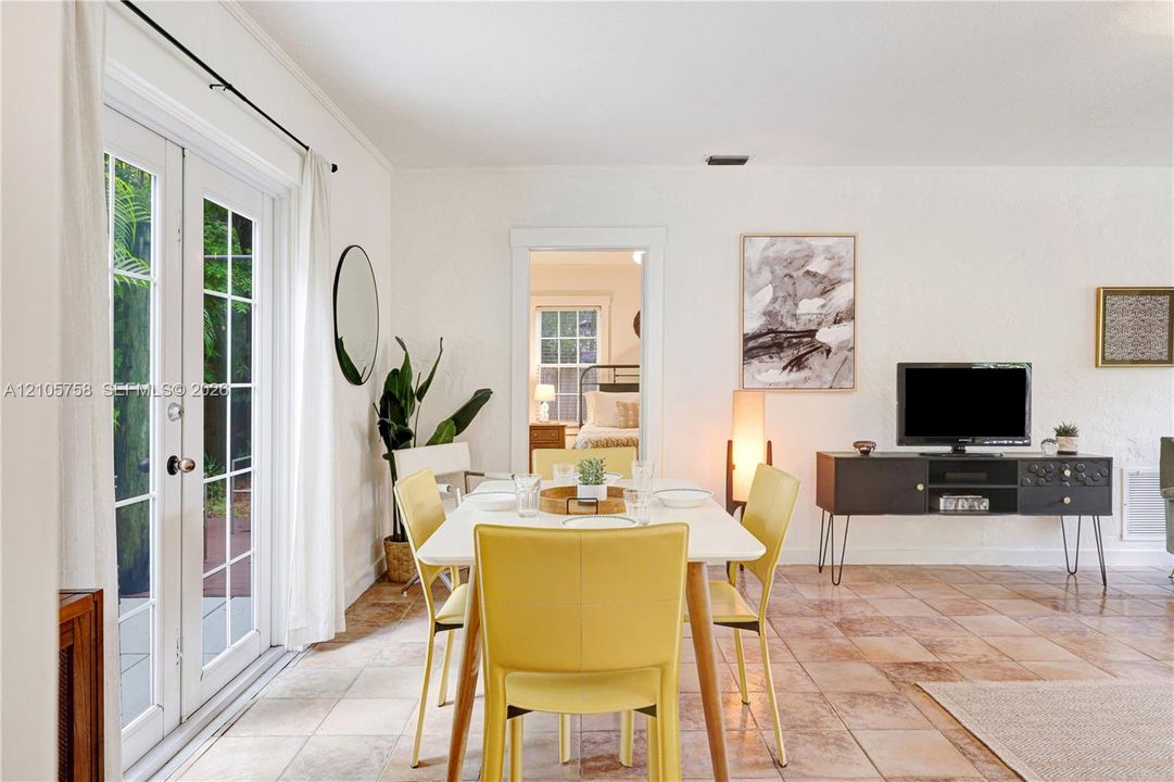 Tile flooring, glass-paned French doors, and a doorway featuring decorative molding