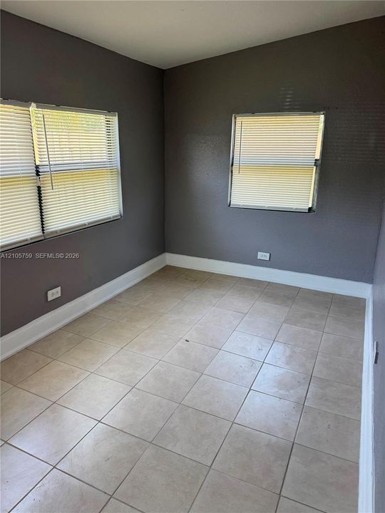 Interior space featuring tile flooring, painted walls, and dual-pane windows