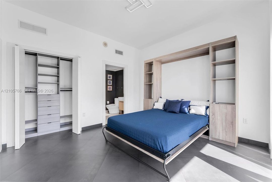 Secondary bedroom with fitted reach-in closet, Murphy bed and its own bath.