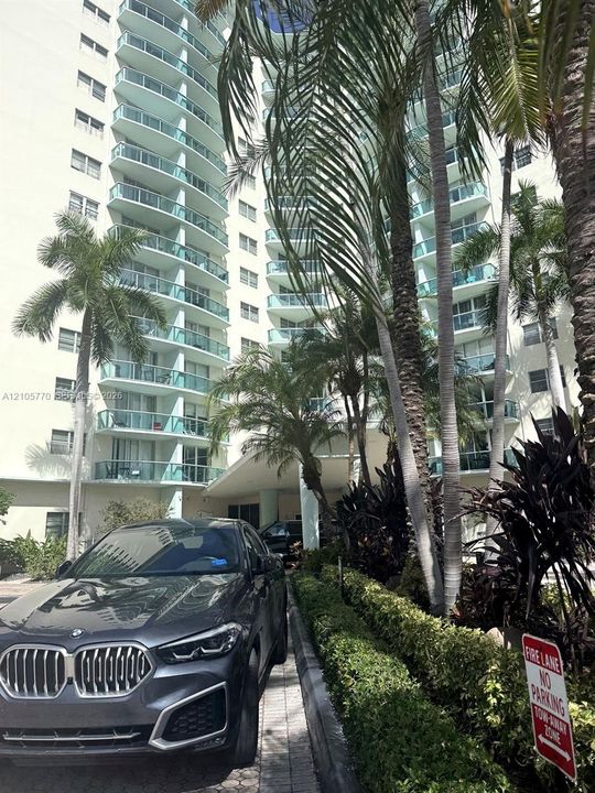 Multi-story building featuring numerous private balconies with clear railings
