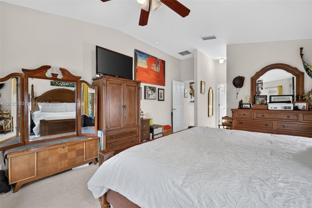 Spacious room featuring a vaulted ceiling and an integrated ceiling fan with light fixture