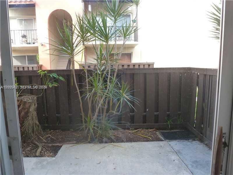 Private patio featuring a concrete floor and wood privacy fencing