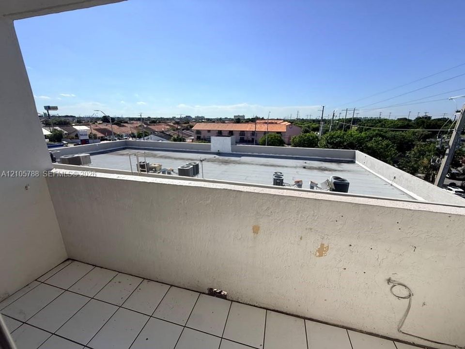 Private balcony featuring stucco walls and ceramic tile flooring
