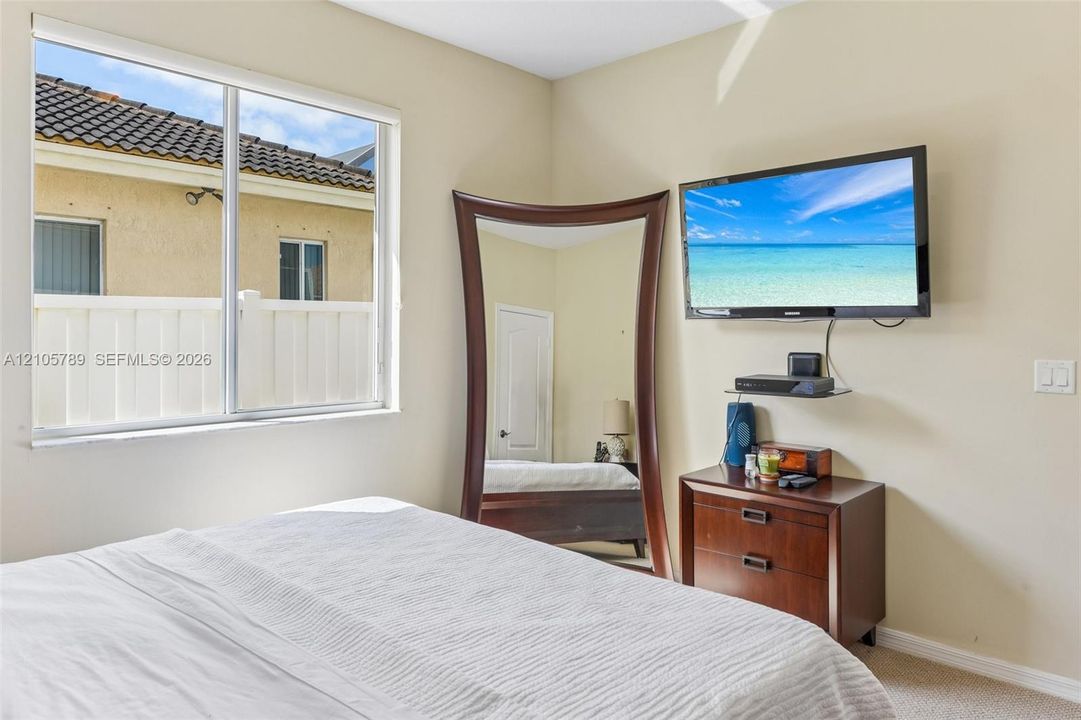 Neutral wall tones, dual-pane slider window, and crisp white interior door