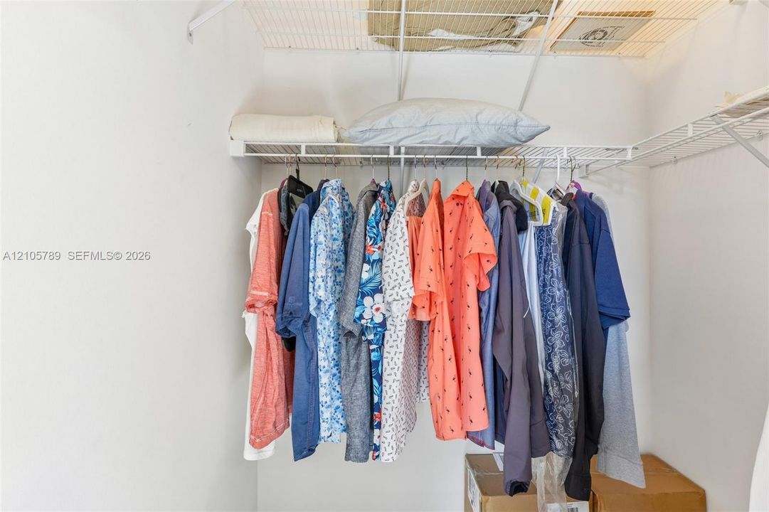 Closet featuring white wire shelving and a horizontal rod for garment storage