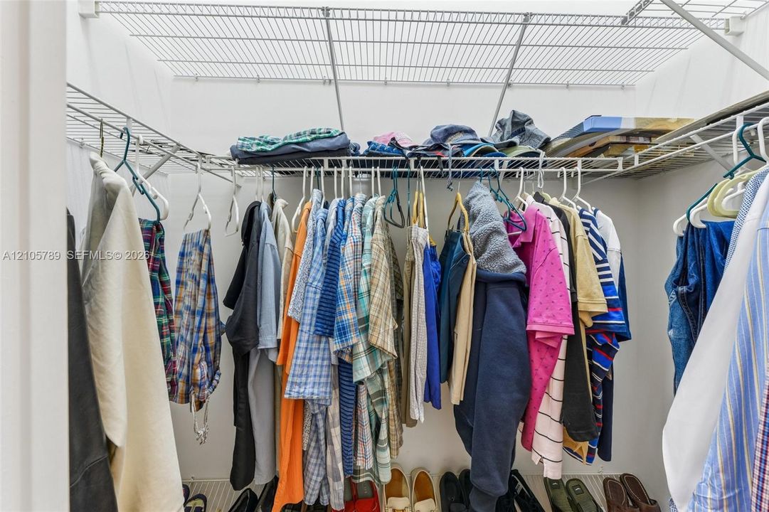Walk-in storage space featuring dual-tier wire shelving