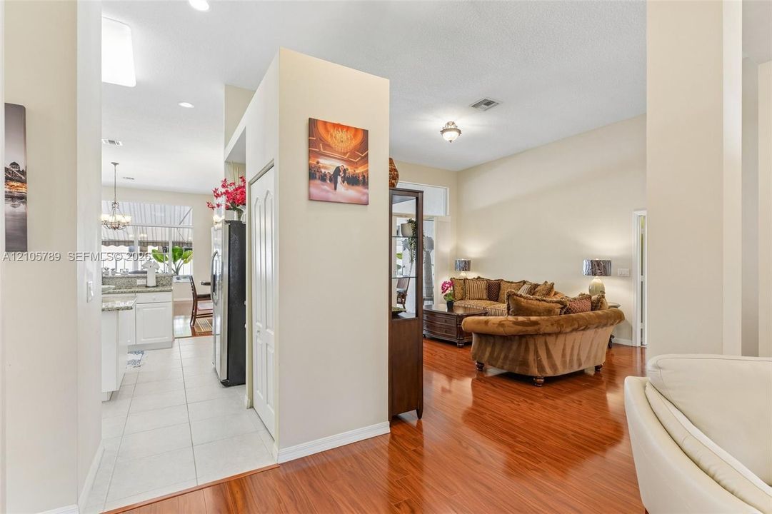 Interior featuring wood-finish flooring, ceramic tile flooring, neutral wall paint, recessed lighting, and high ceilings