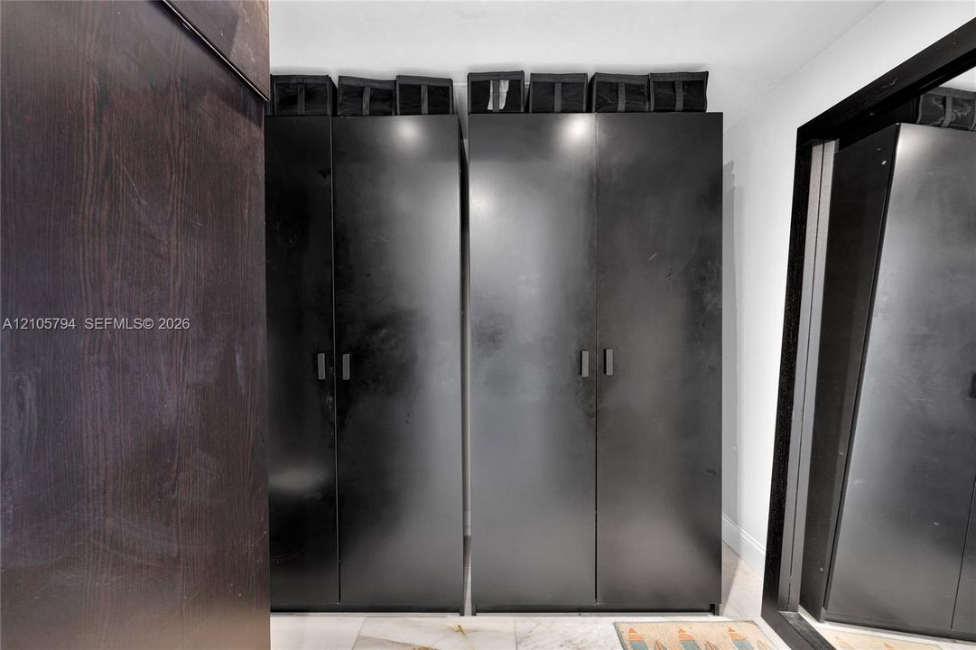 Built-in floor-to-ceiling cabinetry with a matte black finish and minimalist hardware