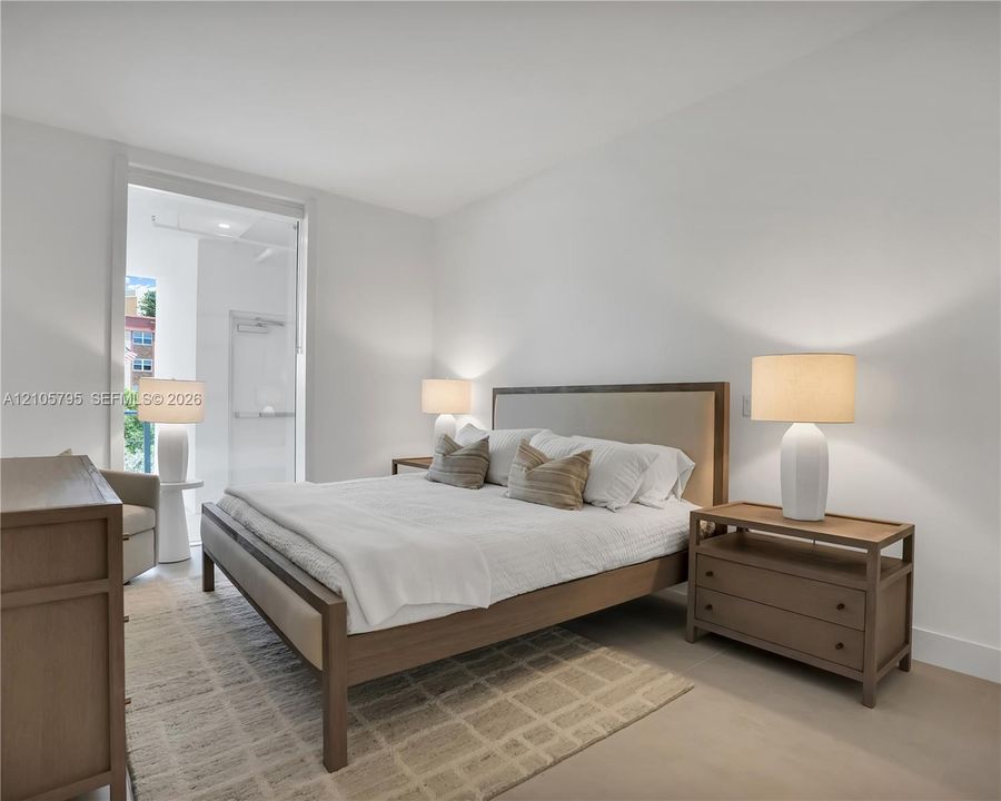 Neutral-toned interior featuring smooth wall finishes, wood-finish flooring, and a glass-paneled entry door