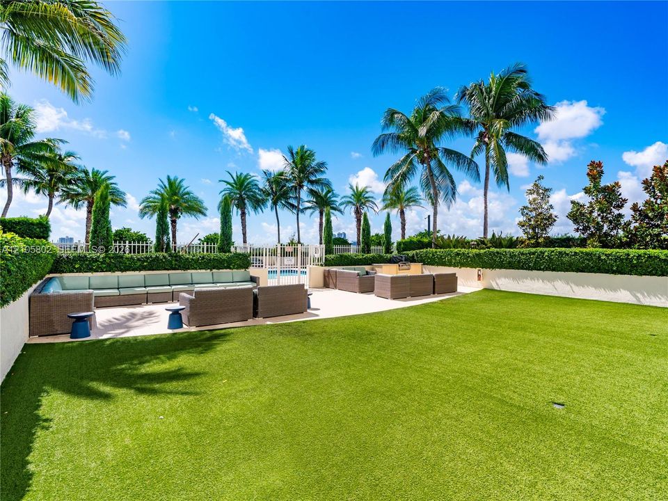 Green deck and sitting areas off of the pool